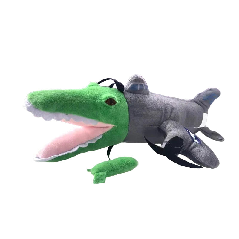 Plush toy with green alligator head and gray body on a white surface, with more plush toys in the background.